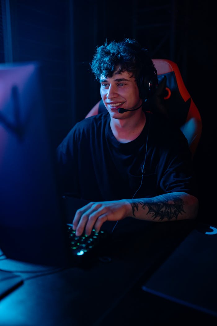 Energetic young man engaged in e-sports gaming with headphones.